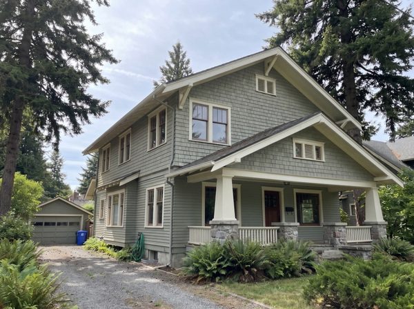 Craftsman exterior after painting, fresh grey-green siding and crisp white trim