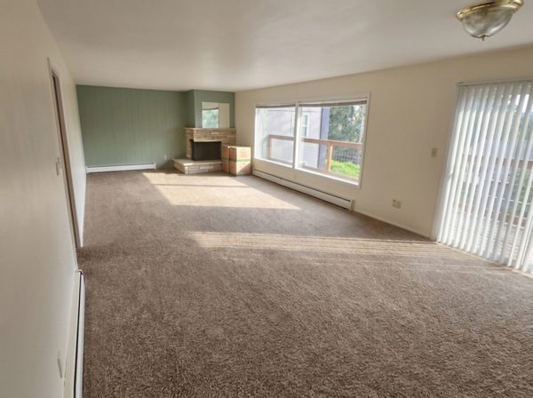 Living room after painting, panelled wall in soft sage and fresh white ceiling